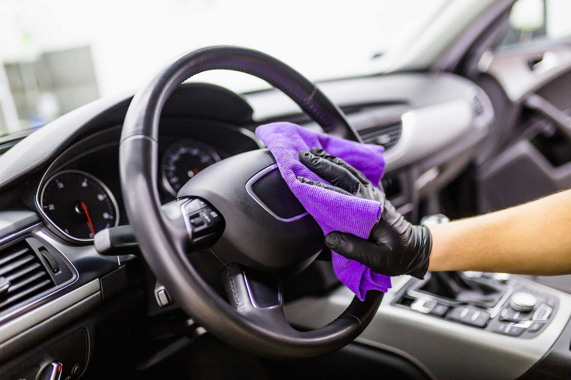 Benny's interior detailing — wiping down the dash and steering wheel